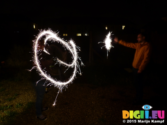 FZ024585 Jenni and Phill setting of sparklers in the garden